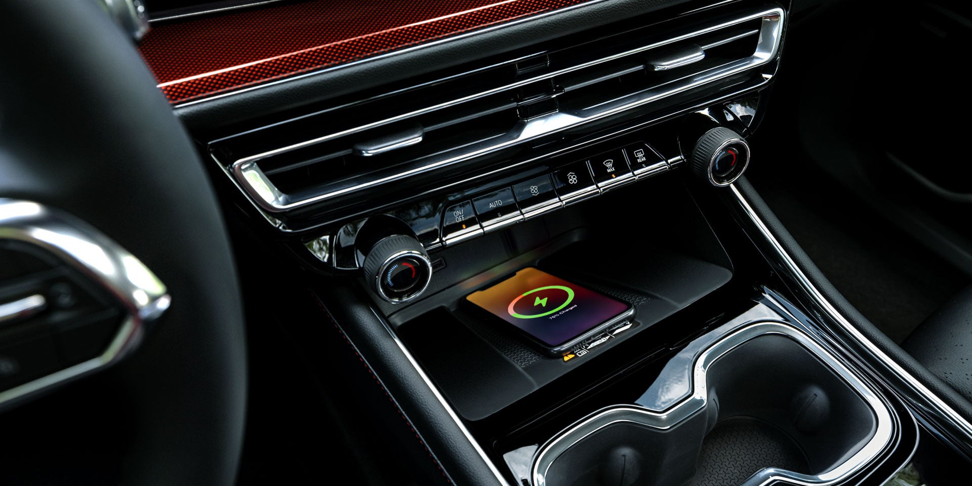 A smartphone lies on a wireless charging pad in a car, displaying a 75% charged battery with a green icon.