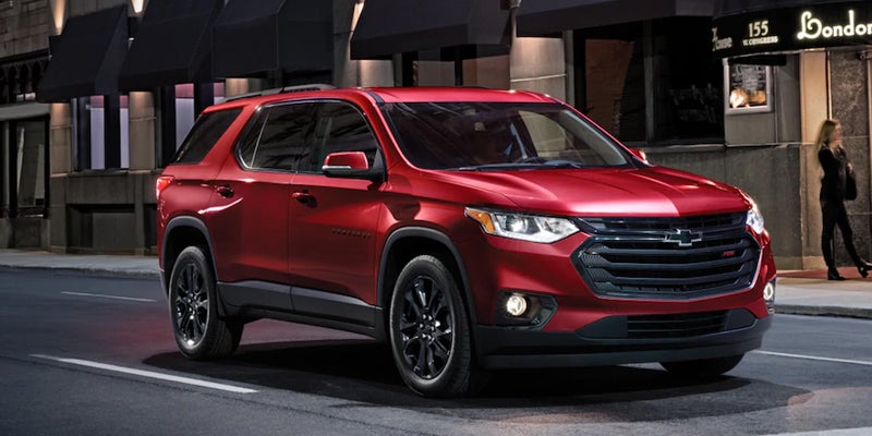 red Chevrolet Traverse on road