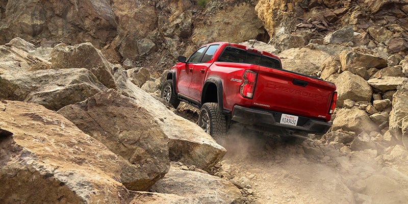 red Chevy Colorado climbing rocky mountain
