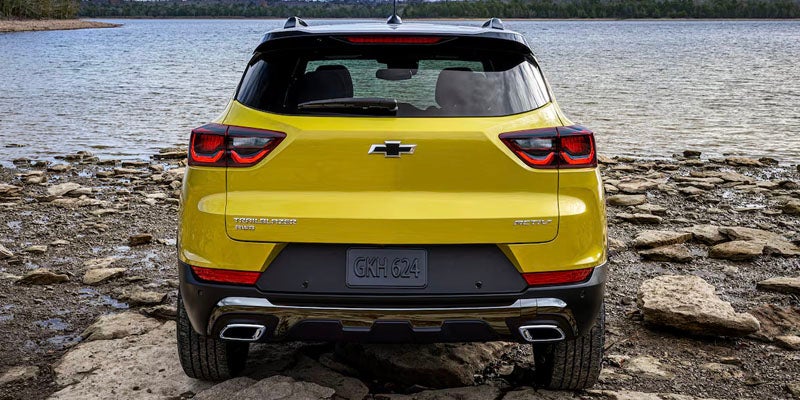 back view of yellow chevy trailblazer parked near river